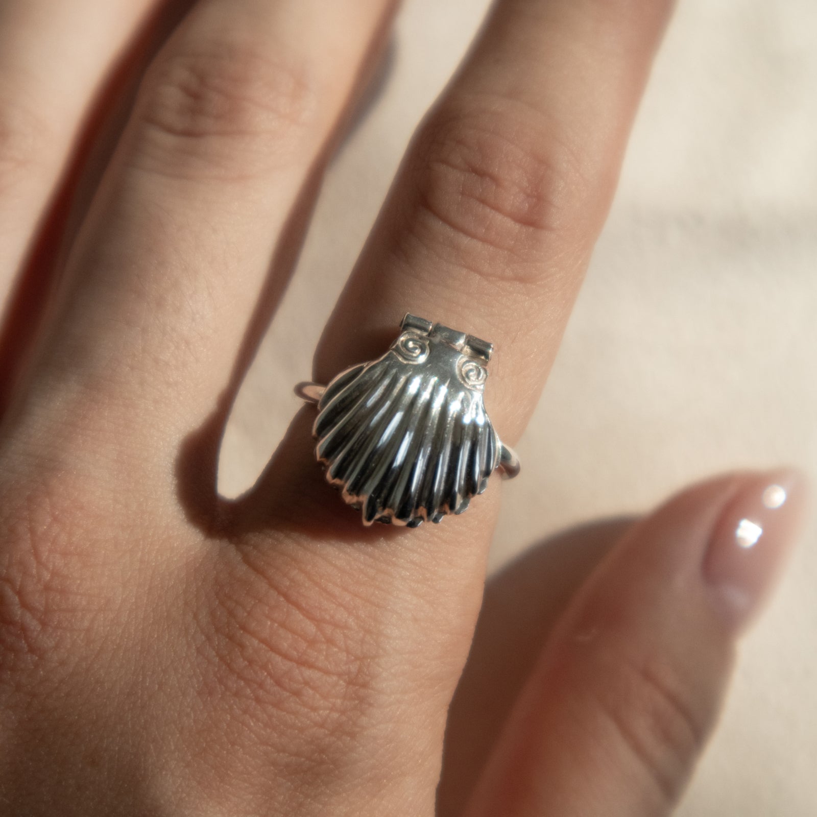 Handmade silver ring with seashell that opens and closes